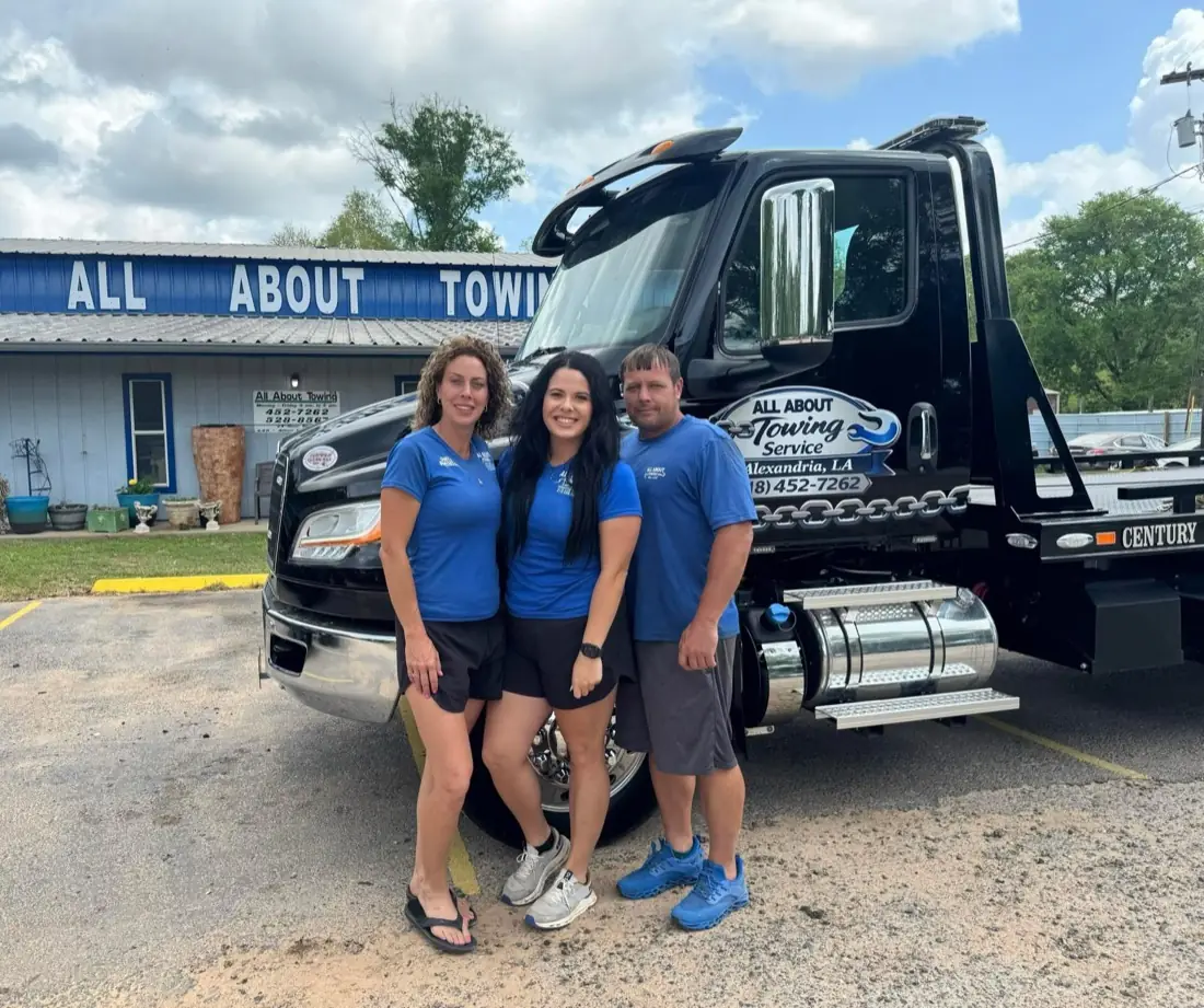 The All About Towing family team in front of their tow truck in Alexandria, LA