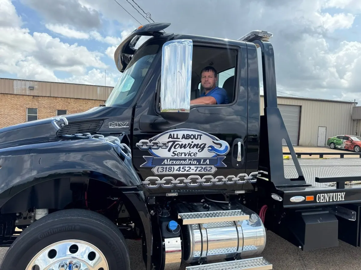 All About Towing owner seated in a branded tow truck